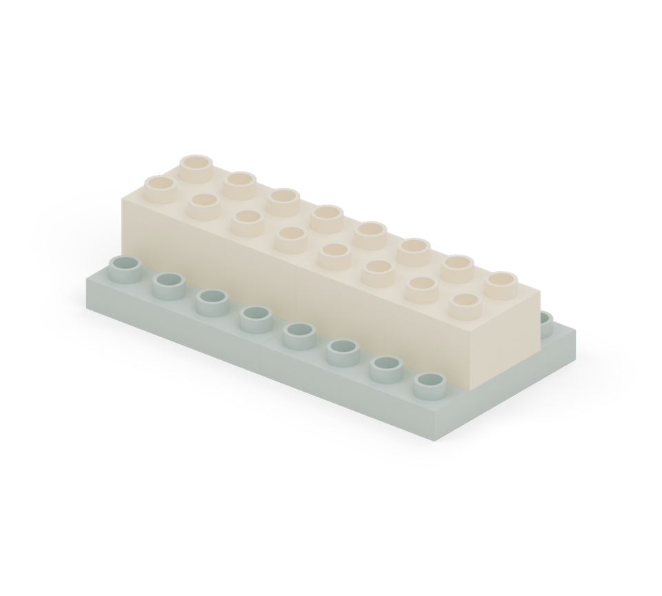 Centre two cream long bricks end to end across the base. Leave one row of green studs showing along each long edge. New additions are shown in their original colours; earlier pieces are lighter.
